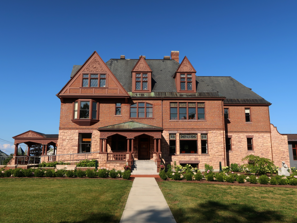 Classic Alumni House at University of Vermont in Burlington, Vermont, named as one of the most beautiful college campuses, with its brick walls, tile roofs, and glass windows