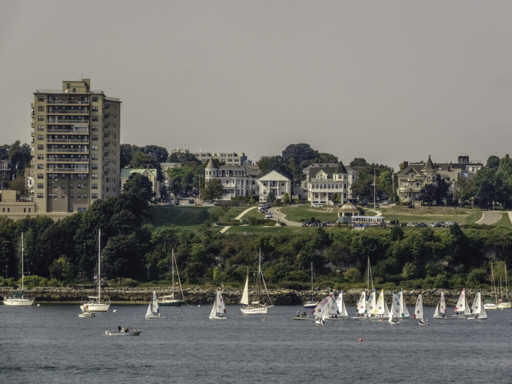 Sailboats on the water with Fort River overlooking the ocean for a piece on the best places to stay in Portland Maine