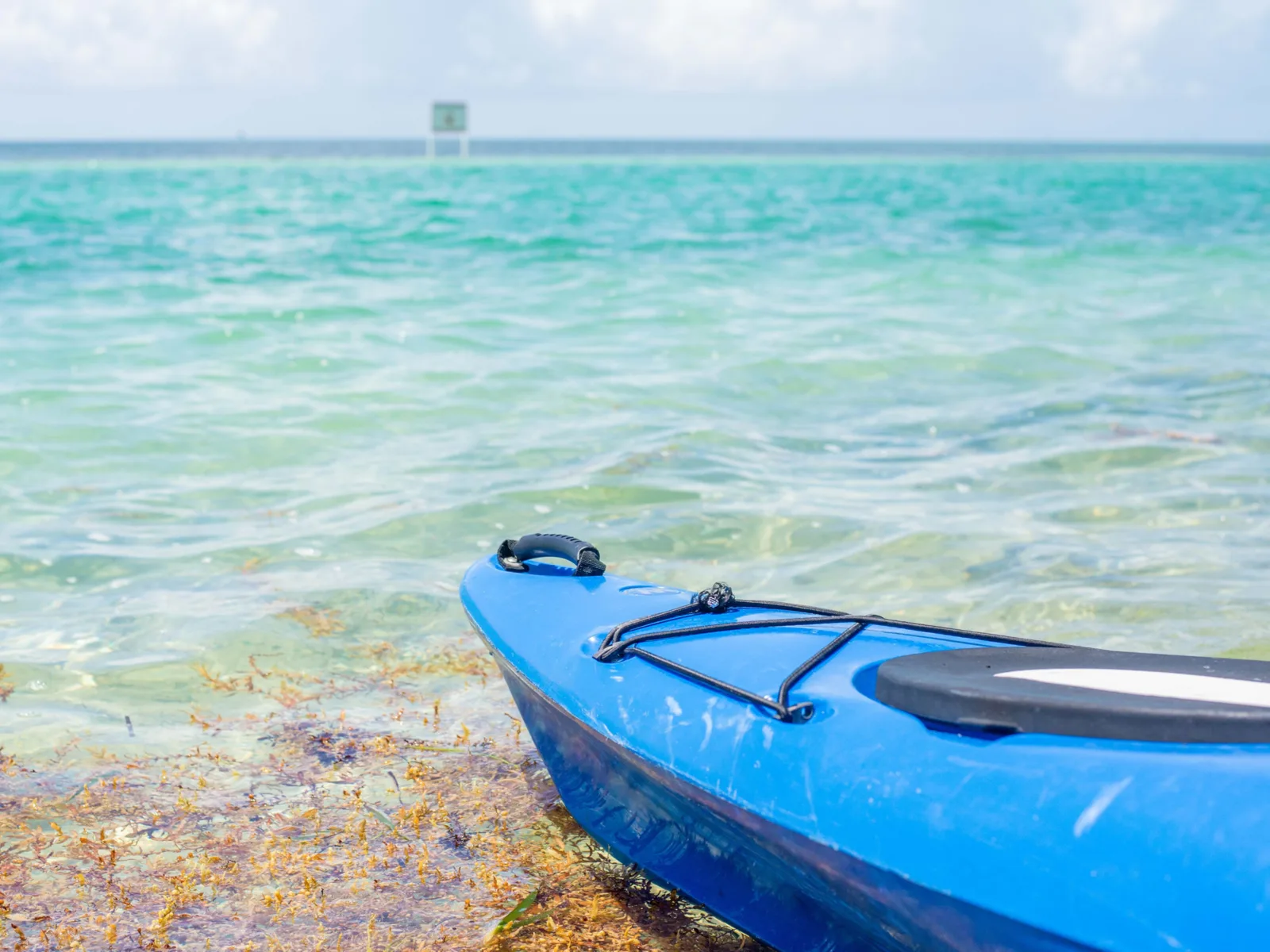 Islamorada beach with a blue kayak on the water for a piece on the cheapest time to visit the Florida Keys