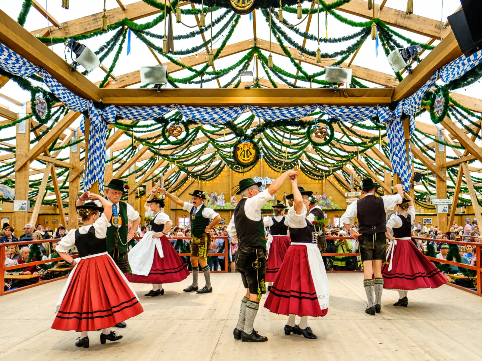 People in a traditional beer hall in traditional clothing during the best time to go to Germany