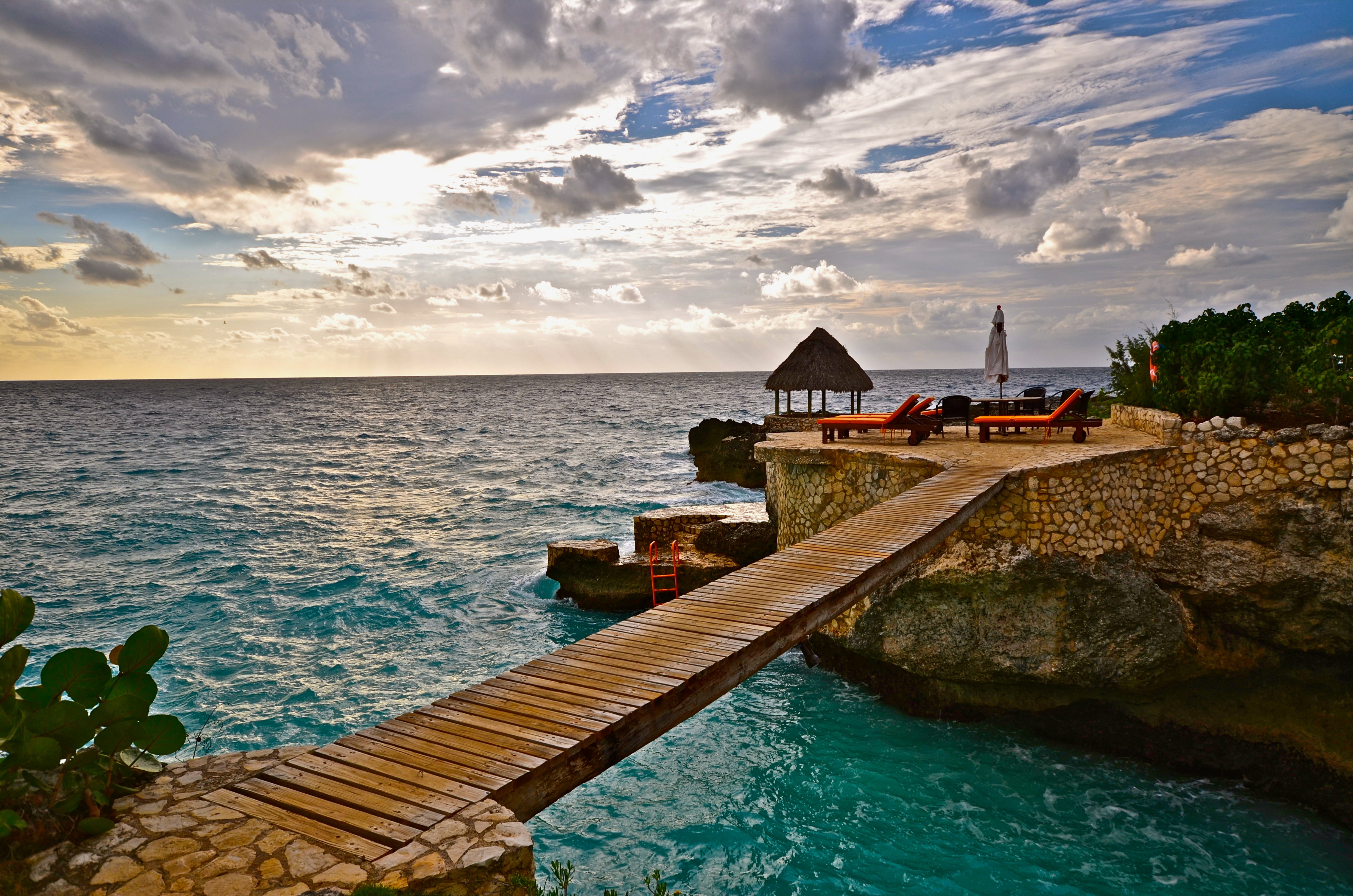 Bridge on one of the best resorts in Jamaica pictured at sunset with a patio overlooking the ocean