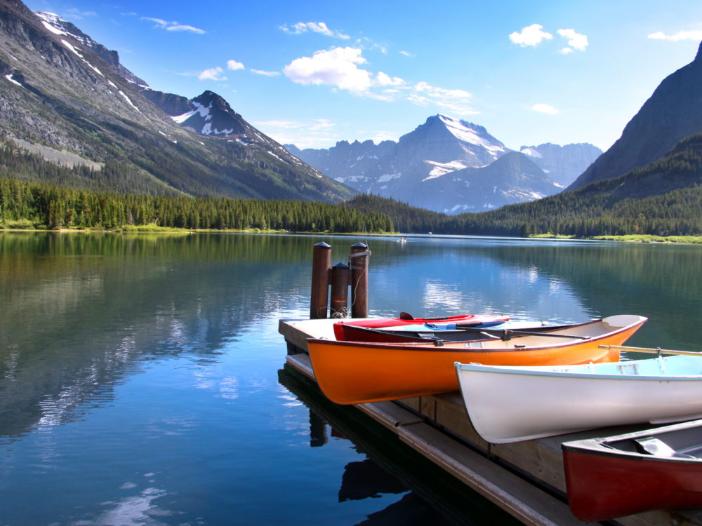 Canoes on Lake McDonald in Glacier National Park during the best time to visit Montana