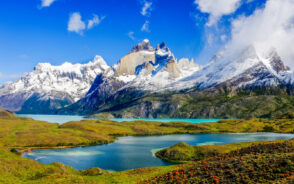 Mountains with a gorgeous lake pictured during the best time to visit Patagonia with blue skies