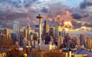 Seattle skyline at sunset, WA, USA for a post titled Is Seattle Safe to Visit