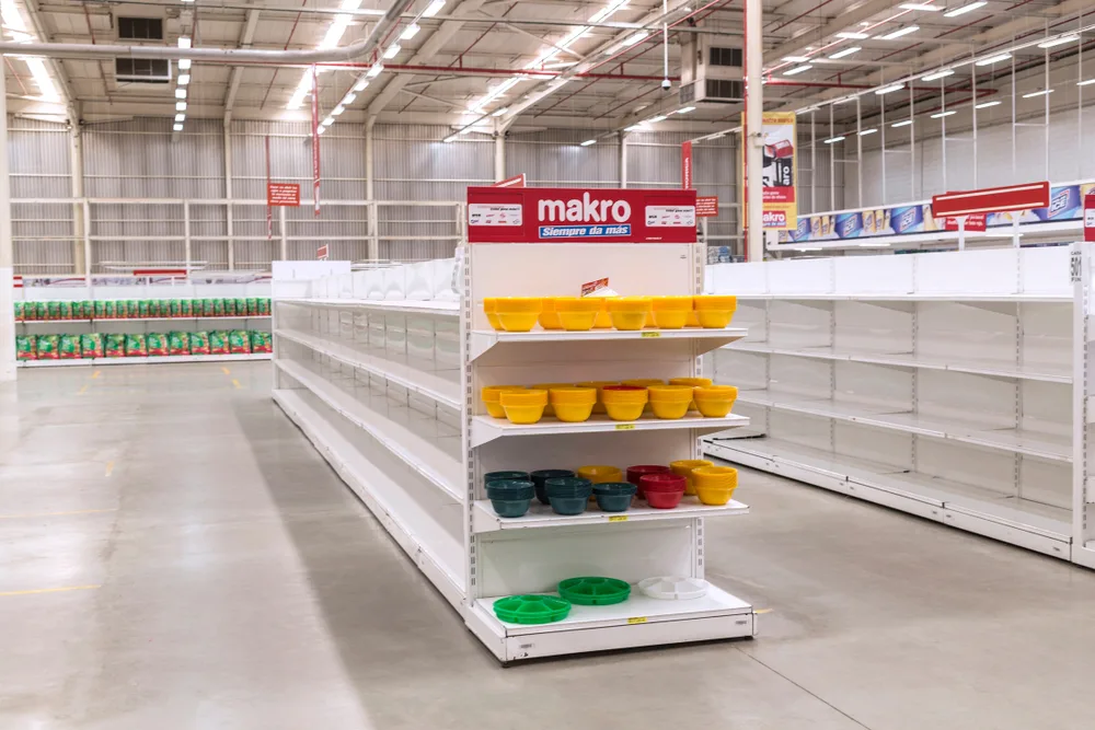 As an image for a guide on Is Venezuela Safe to Visit, a number of shelves in a store are completely empty
