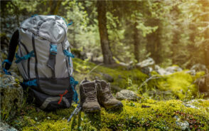 Featured image for a piece on the best hiking backpacks featuring a pack sitting on a mossy rock