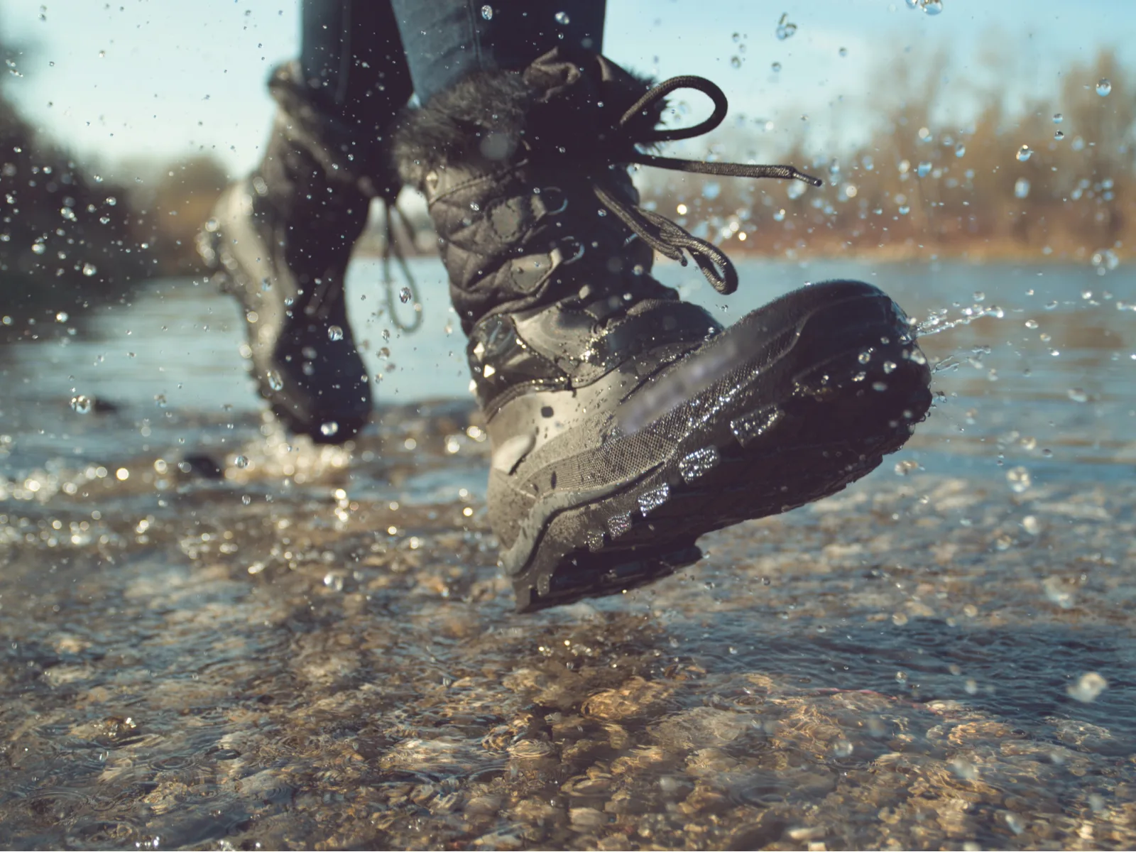 Guy trapesing through a deep stream to illustrate why you need the best waterproof boots for men