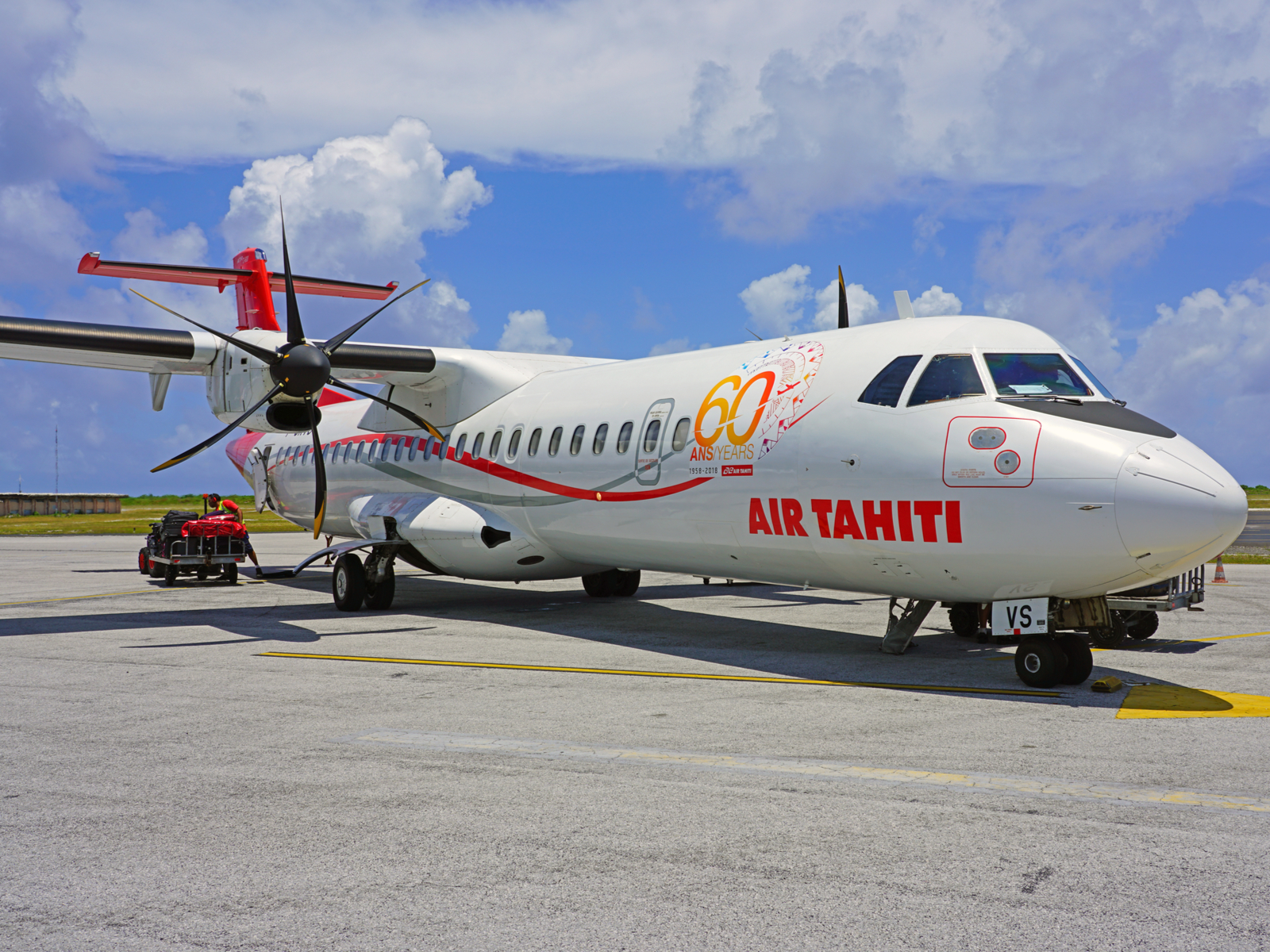 ATR regional airplane on the ramp on a sunny day during the best time to visit Tahiti
