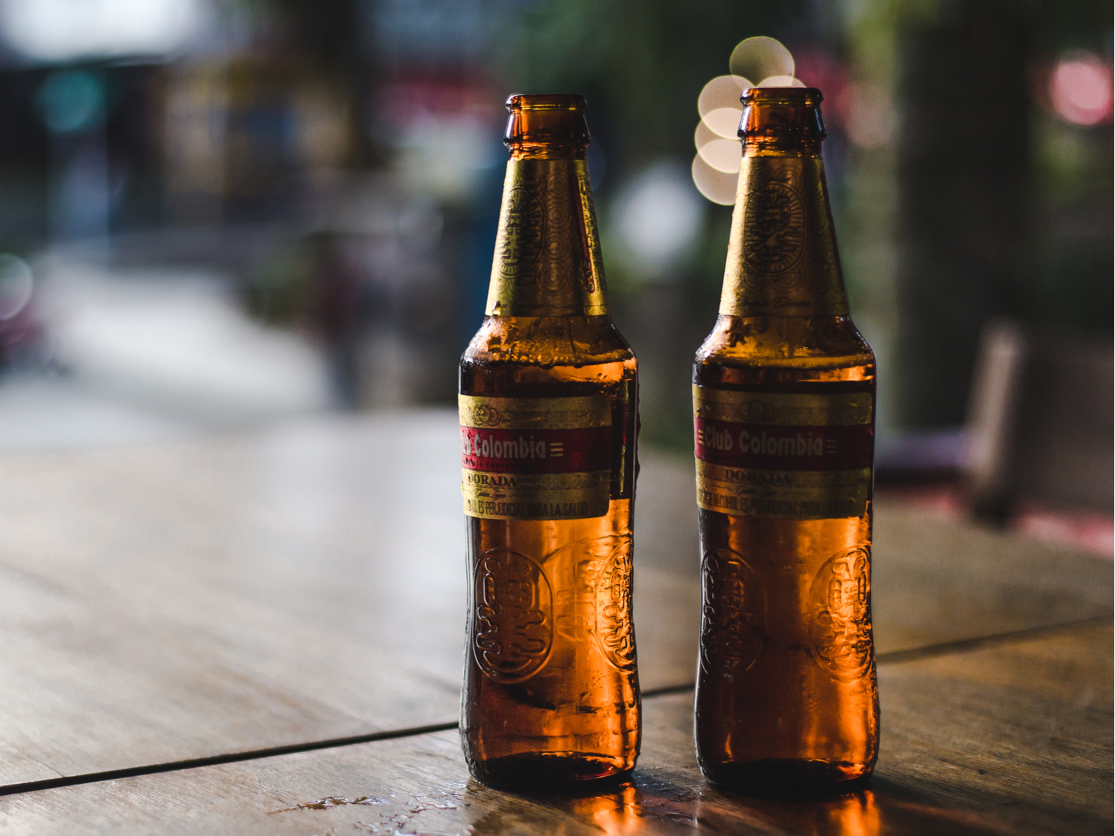 Brown bottles of Colombian beer sit on a table