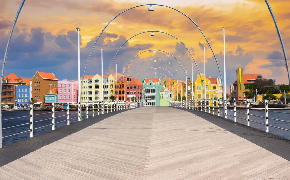 Floating pontoon bridge leading to colorful buildings in Curacao
