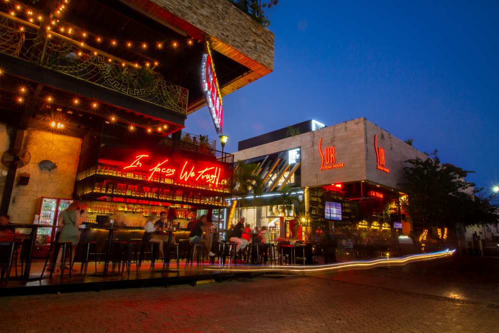 For a piece on Is Playa Del Carmen Safe to Visit, a number of bars and restaurants on a well-lit street