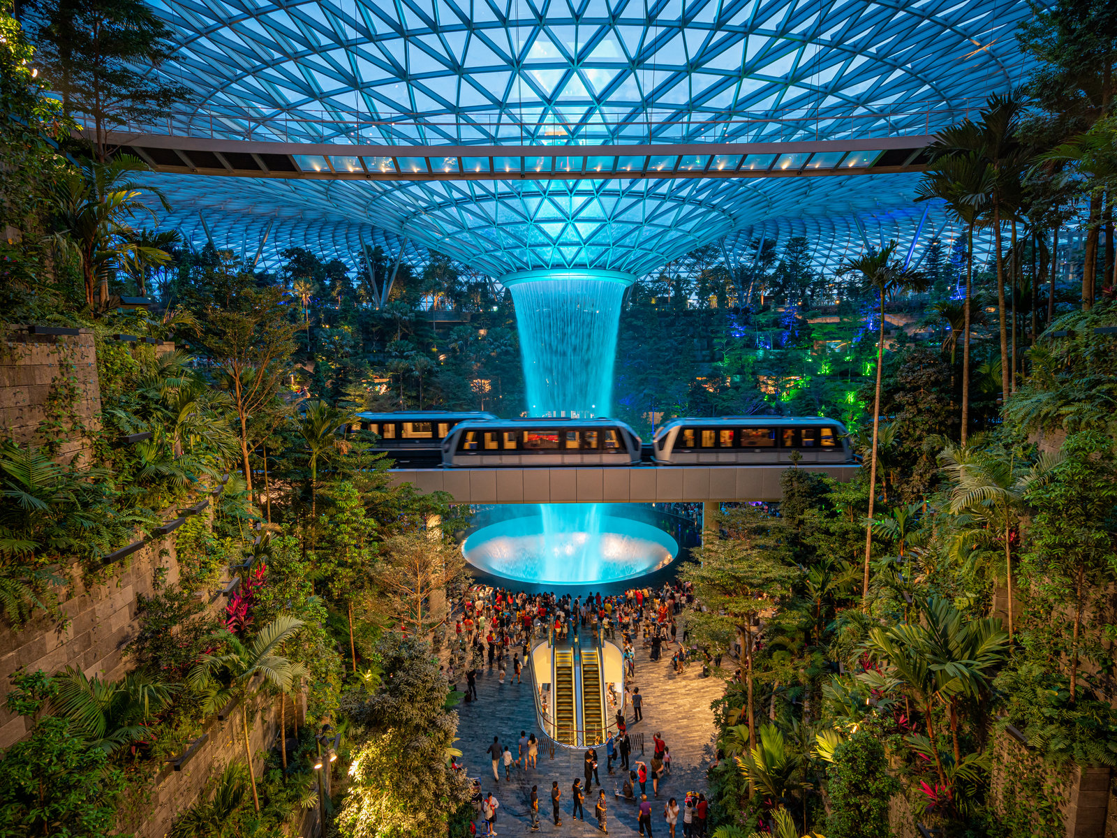 Singapore airport pictured with rain falling from the sky and a tram around it for a piece on the best time to visit Singapore