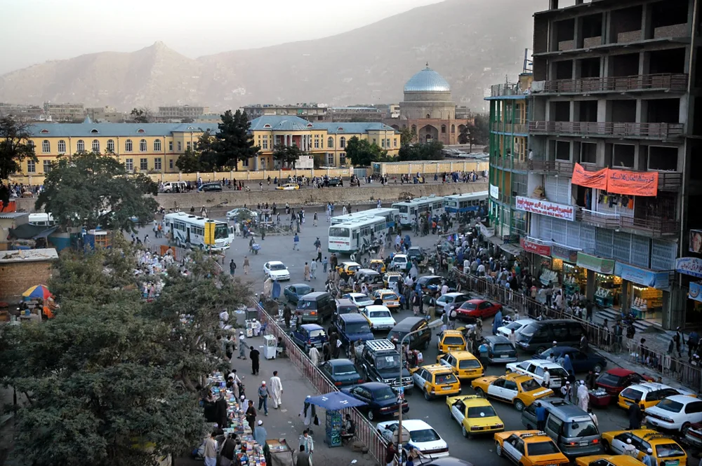 Aerial view of Kabul with lots of taxis and busses pictured in the middle of the city