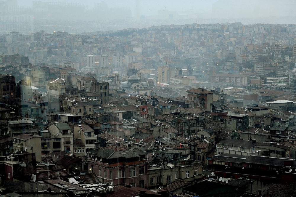 Tarlabasi neighborhood pictured with lots of run-down homes on a foggy day as a part of Istanbul to avoid