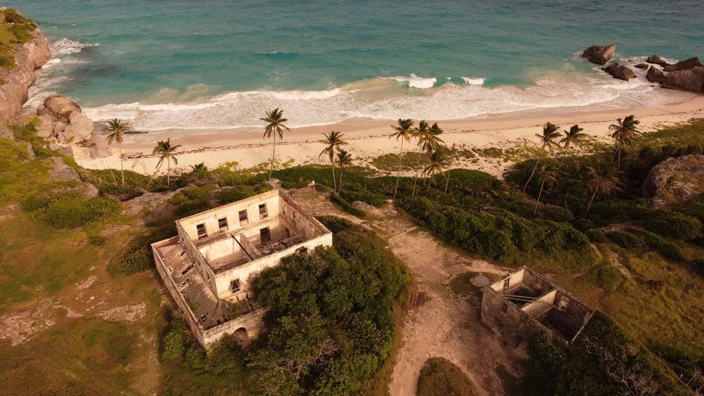 Abandoned building on a beach facing the ocean for a piece titled Is Barbados Safe