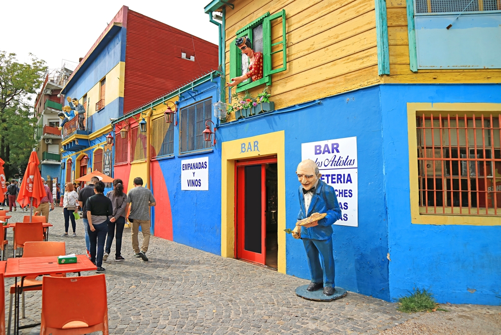 Bright colored buildings on a brick street for a piece on whether Argentina is safe to visit or not