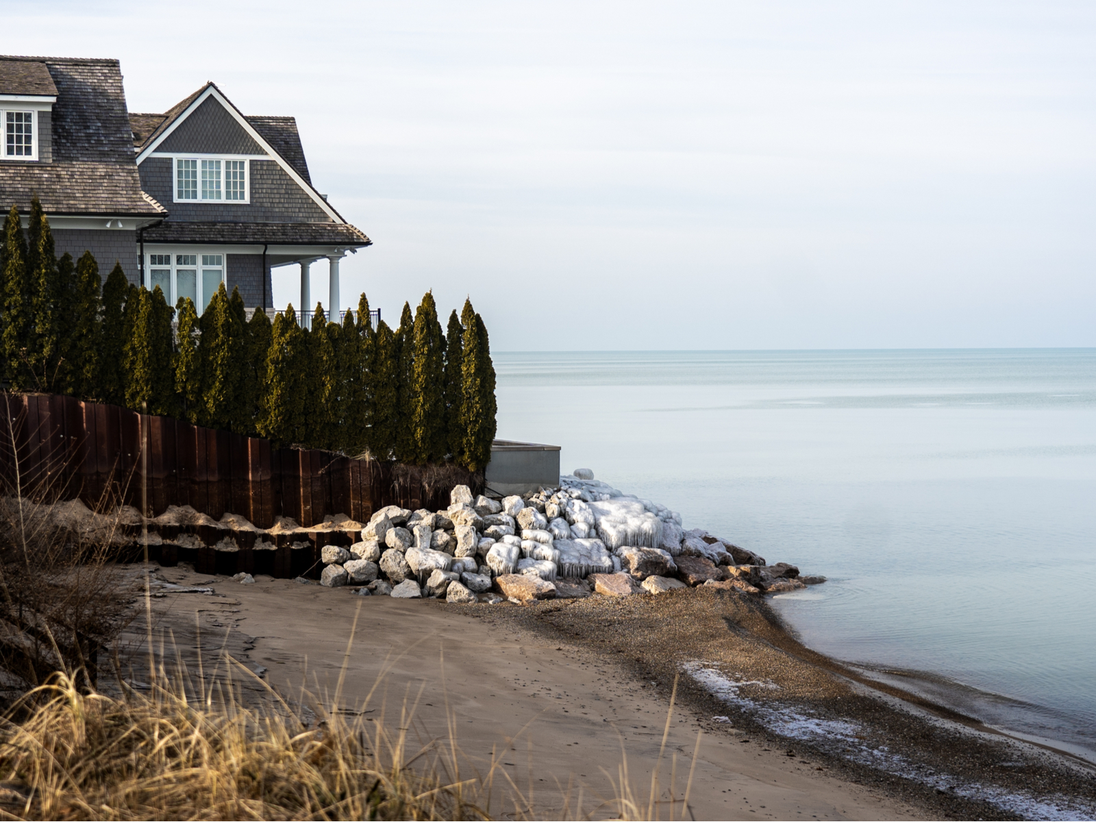 For a piece on the best Airbnb stays in Michigan, a photo of a cabin overlooking Lake Michigan on a cloudy day