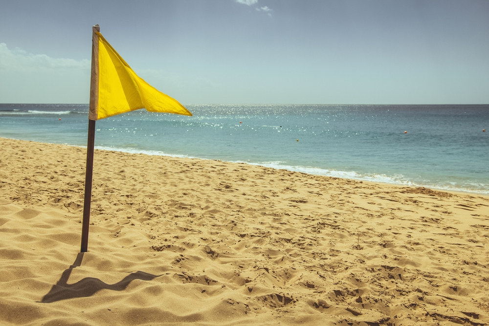 Yellow flag on a beach in Barbados