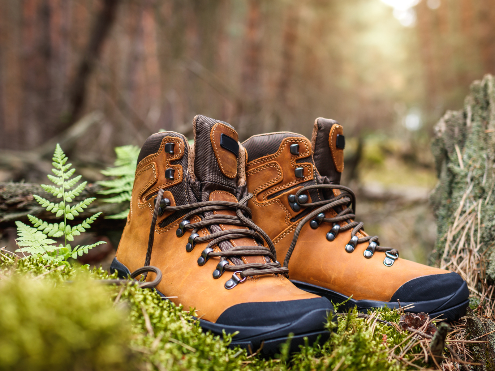 For a piece on the best waterproof boots for men, a pair of tan boots sits on some greenery