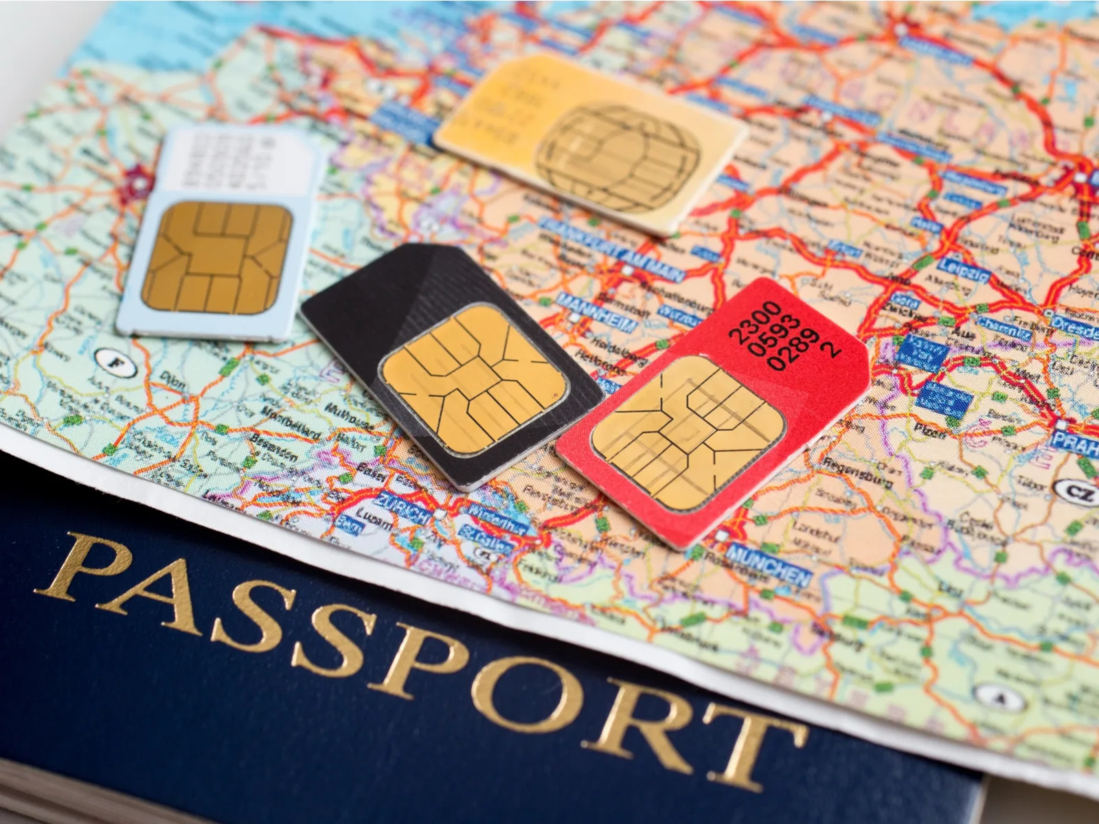 Image of some of the best international sim cards sitting on a passport and a map