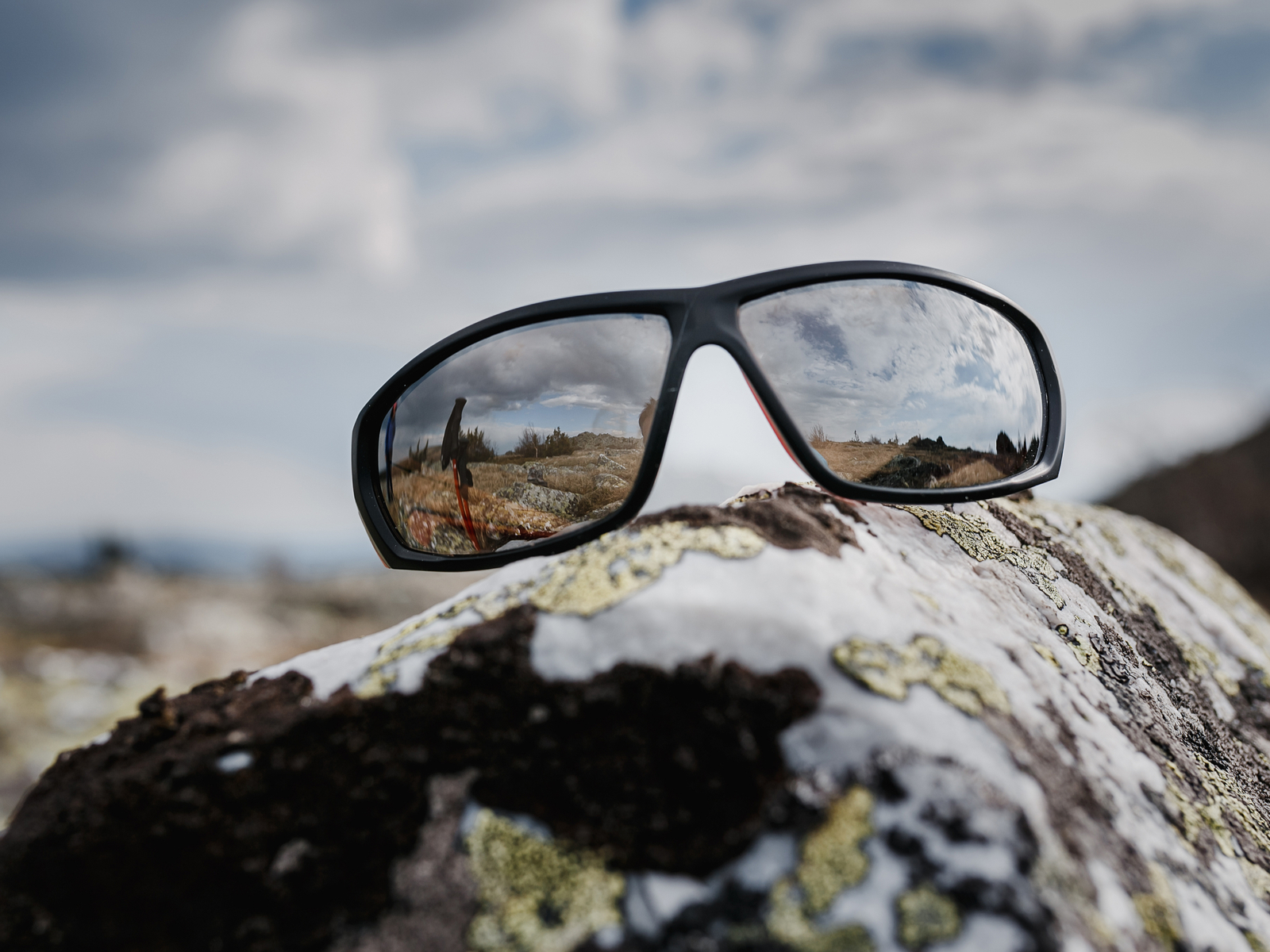 For a piece on the best hiking sunglasses, a pair of nice looking glasses sits in full-frame on a rock