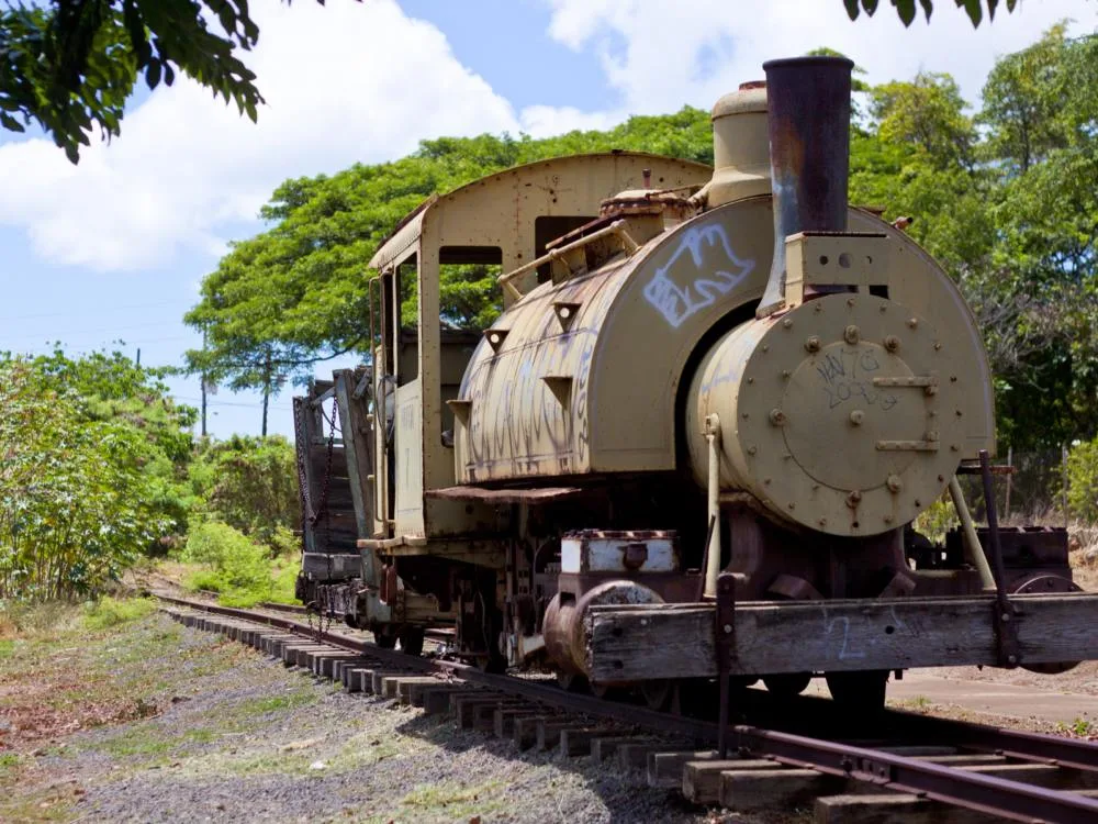 An old plantation train idled for a long time with rusts and vandals on its body at the Old Plantation Village, one of the best things to do in Oahu