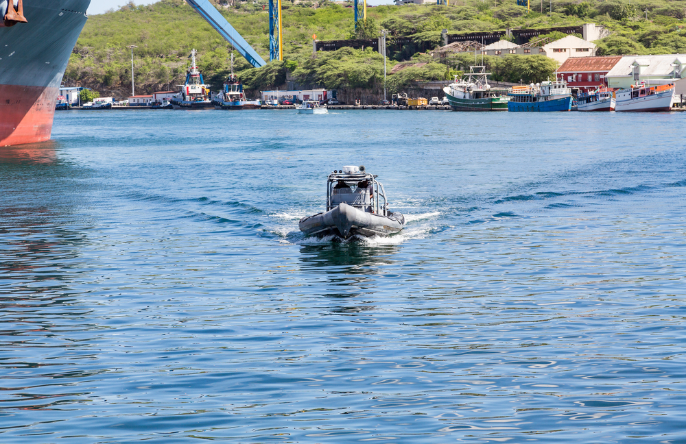 Image of a boat motoring along the bay with Curacao in the background