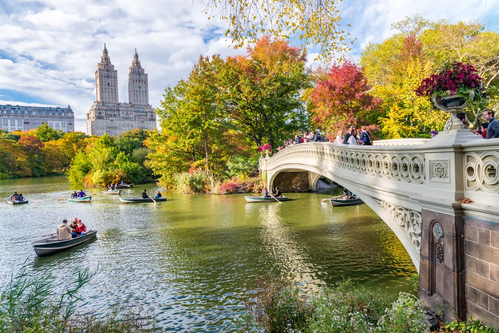 Central Park pictured with people on boats below the bridge for a post titled Is NYC Safe to Visit