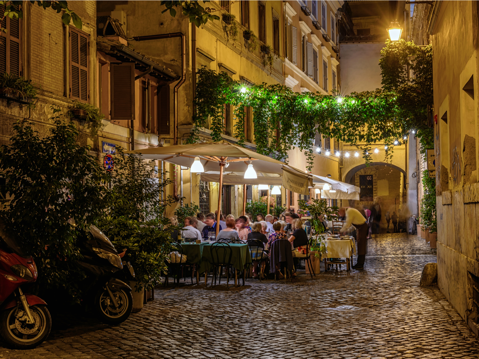 Night view of a cozy street in Trastevere during the cheapest time to visit Rome