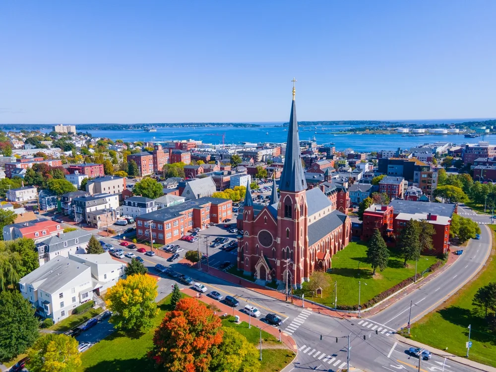 Aerial shot of Portland, one of our picks for a piece on where to stay in Maine with the cathedral in the foreground