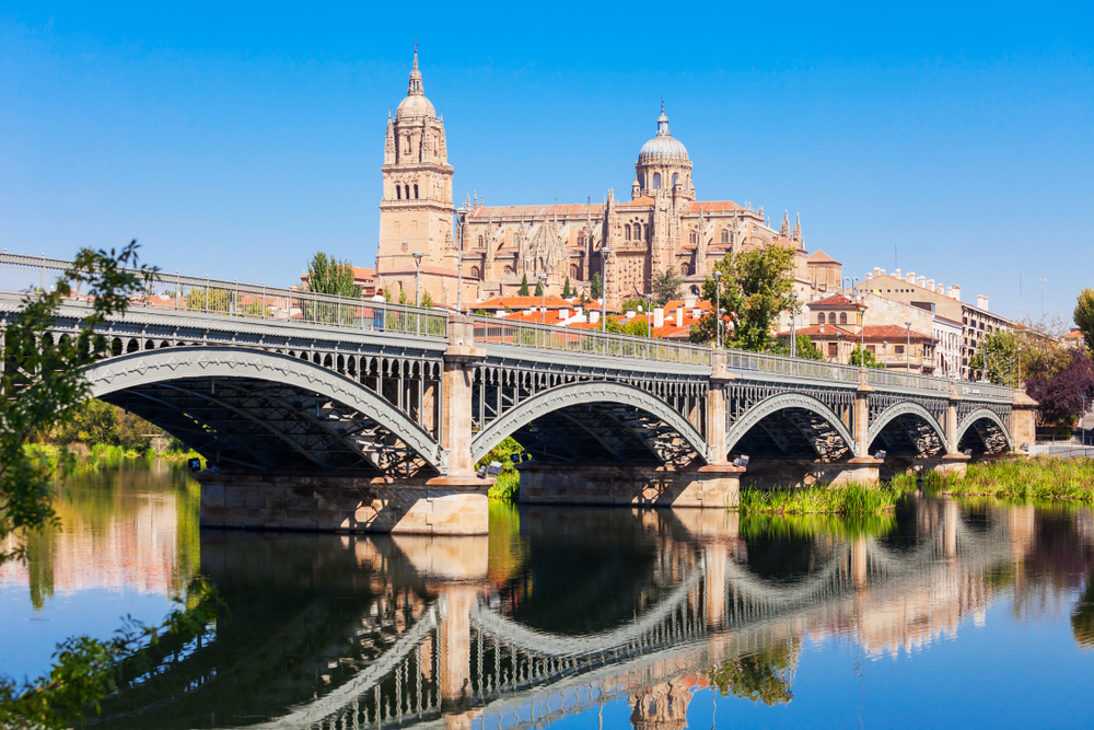 Gorgeous view of the Salamanca Cathedral as seen from under the bridge and across the river
