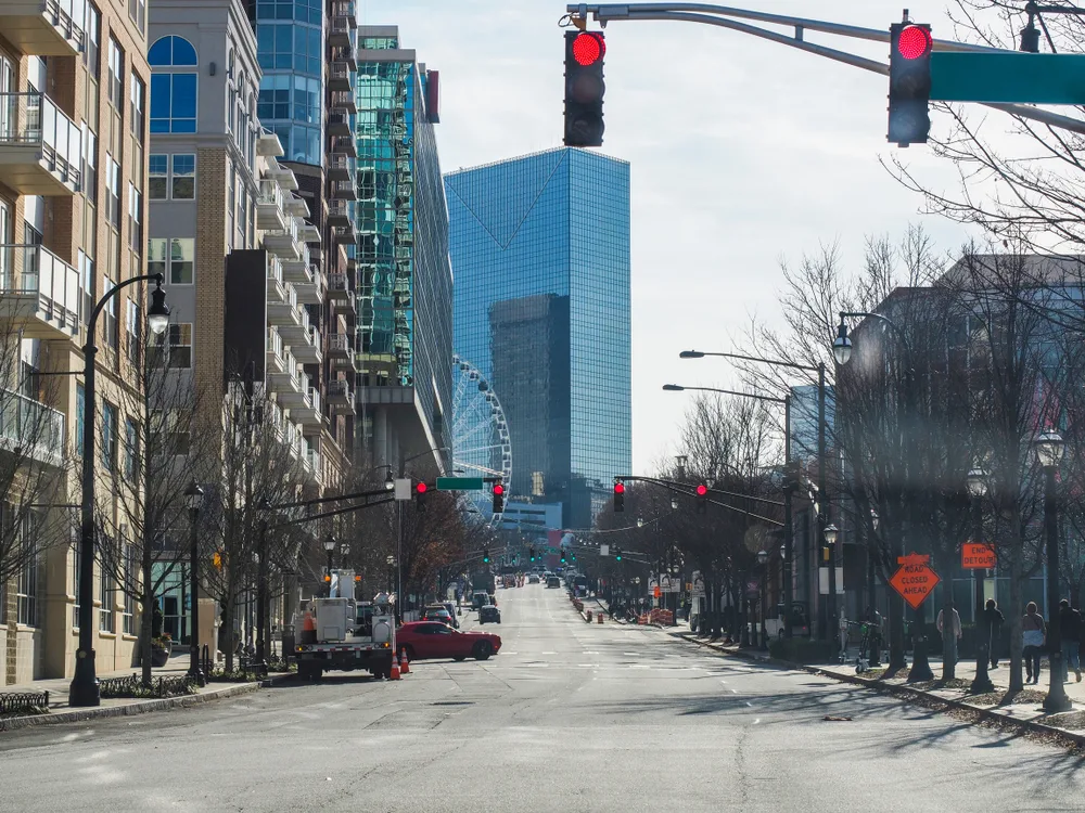Downtown street with large buildings on either side with snow on the ground pictured during the cheapest time to visit Atlanta