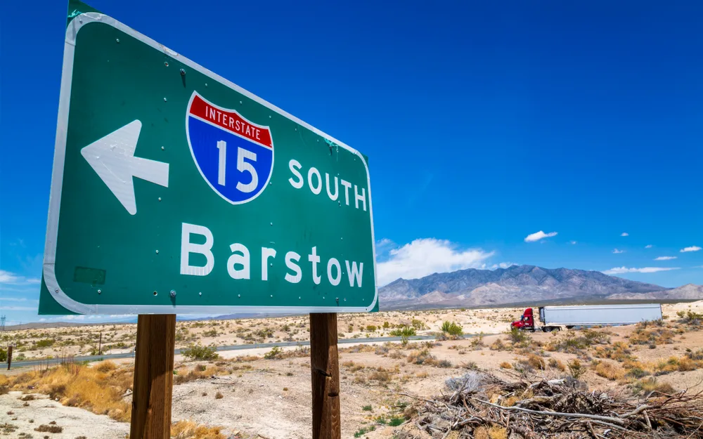 Cool green traffic sign with highway 15 that says Barstow for a piece on where to stay in Death Valley