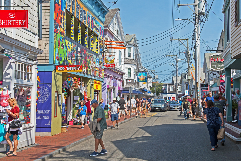 Shops lining the street of Provincetown pictured during the high-traffic time during the summer for a piece on Where to Stay in Cape Cod