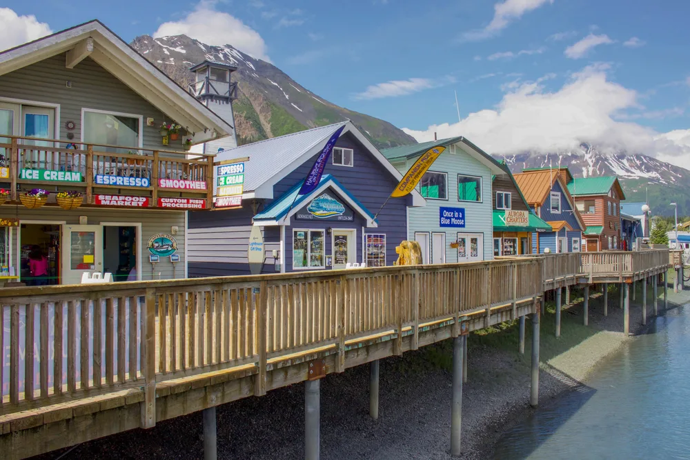 Unique row of colorful buildings on the pier of an ocean in Seward, one of the best places to visit in Alaska