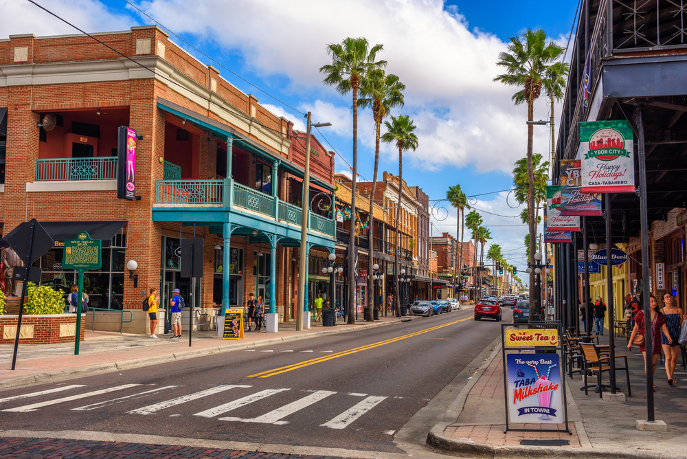 Photo of Ybor City, one of our picks when considering where to stay in Tampa, pictured on a sunny and busy day