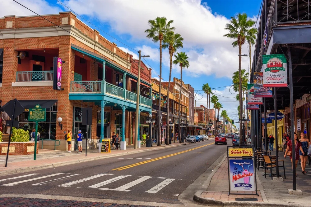 Photo of Ybor City, one of our picks when considering where to stay in Tampa, pictured on a sunny and busy day
