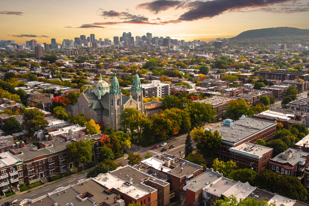 Plateau Mont-Royal as seen from the air at dusk with clouds in the sky for a piece on where to stay in Montreal
