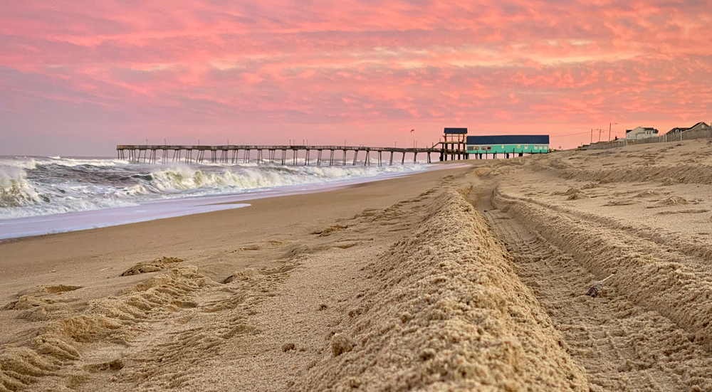 For a piece on Where to Stay in the Outer Banks, a gorgeous view of the Avalon Pier at Kill Devil Hills with a pink sky in the background