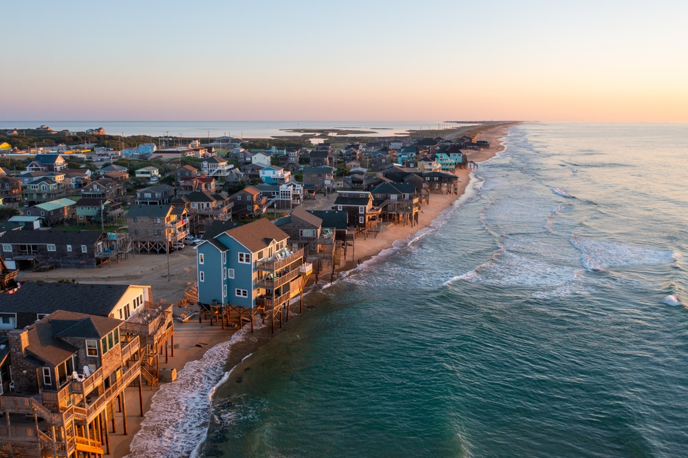 Aerial view of homes along the waterline of Buxton, one of the best places to stay in the Outer Banks