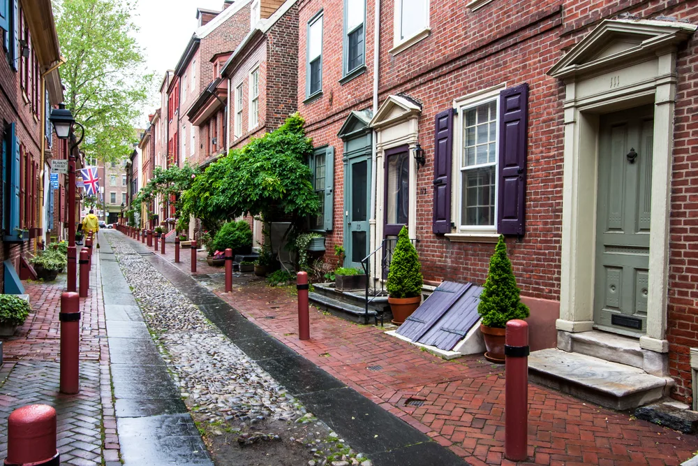 Gorgeous red brick homes pictured from the outside on a walking path for a piece on where to stay in Philadelphia