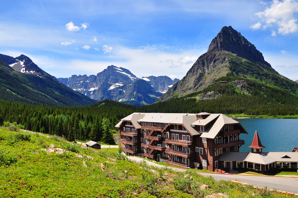 Many Glacier, one of the best areas to stay in Glacier National Park, as seen from a hillside in front of a resort