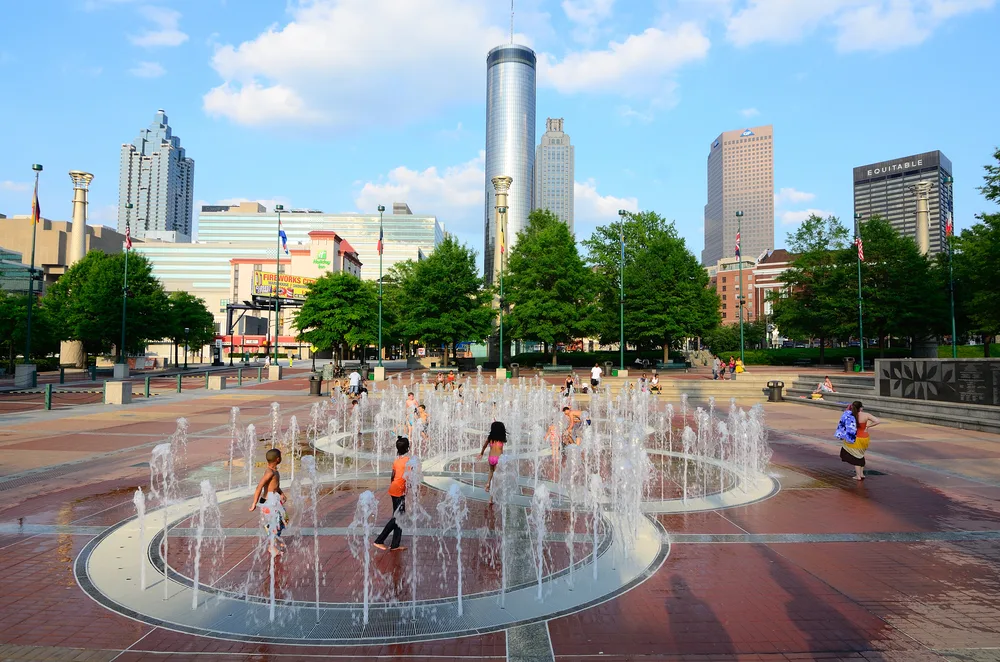 Kids playing in a fountain on a splash pad in May, one of the best times to visit Atlanta