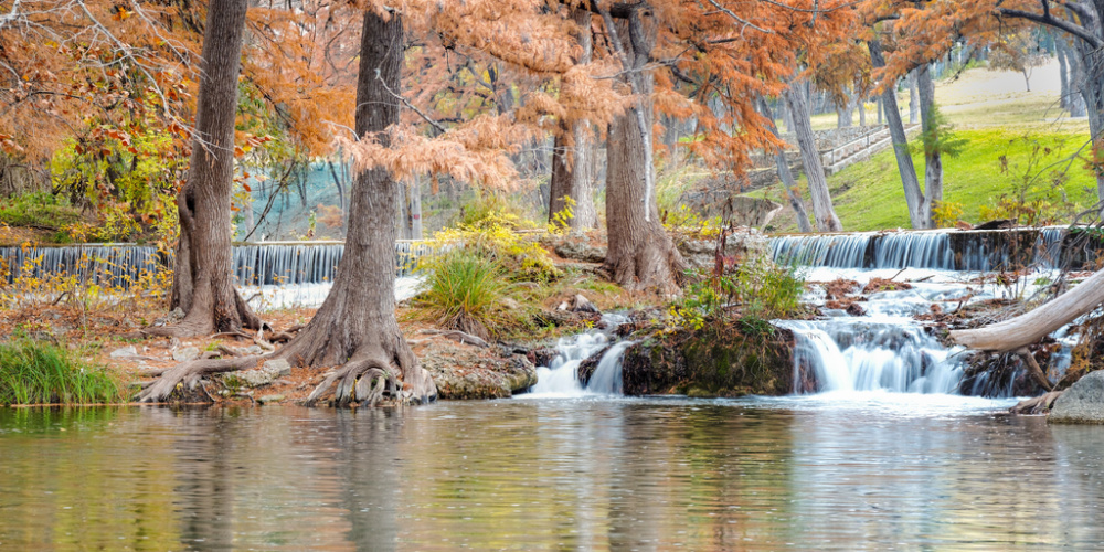 Panoramic view of the Guadalupe River running through Kerrville in fall, one of the best places to stay in Fredericksburg TX