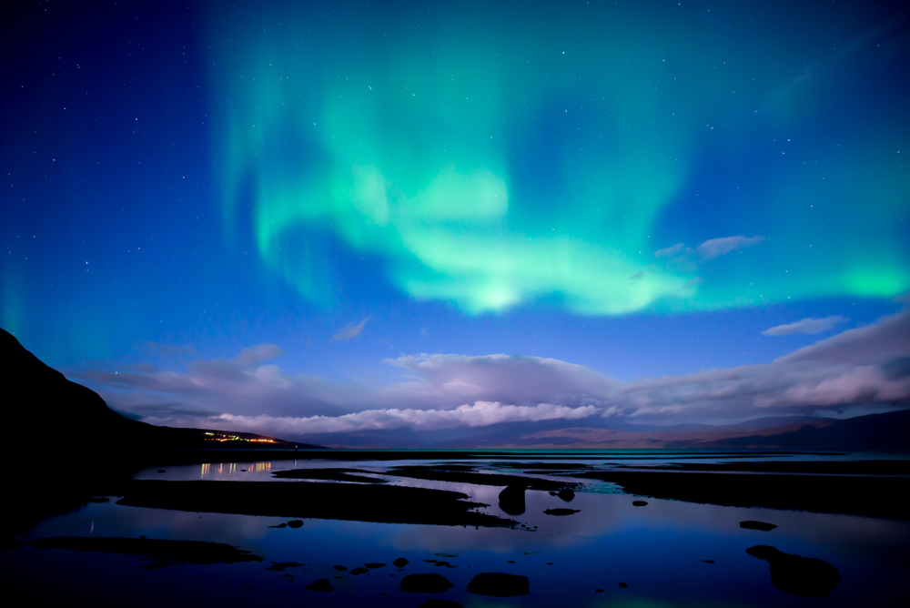 Northern Lights or Aurora Borealis over lake in Abisko National Park in Sweden, a very safe place to visit