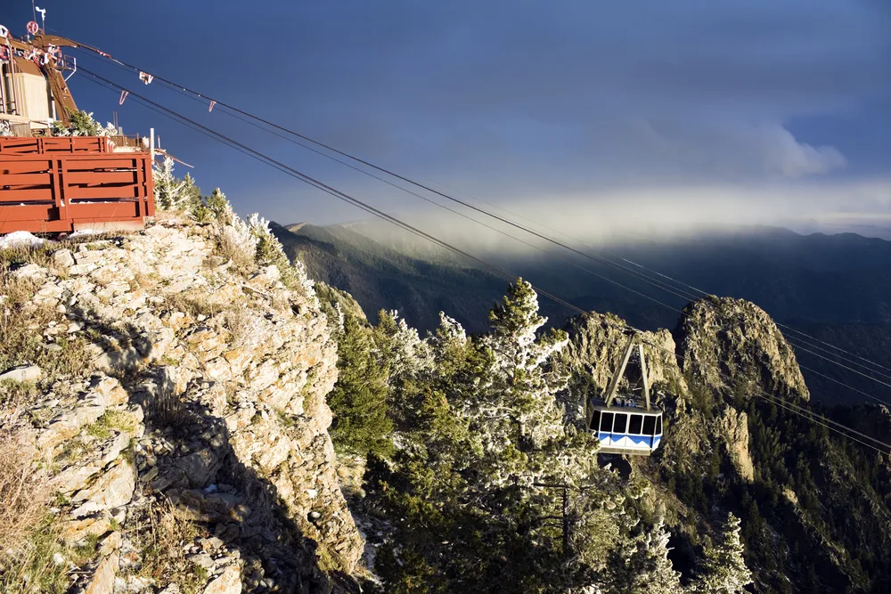 Cable car in the Sandia Mountains pictured from the cliff looking out over the fog-covered mountain during the best time to visit Albuquerque