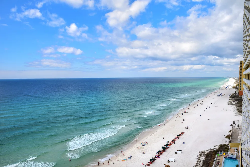 Aerial view of the beach with lots of tourists during the worst time to visit Panama City Beach