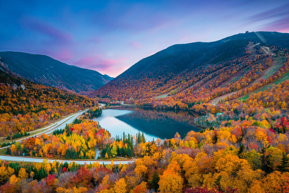 Franconia Notch State Park view at sunset with fall foliage showing the best time to visit New Hampshire