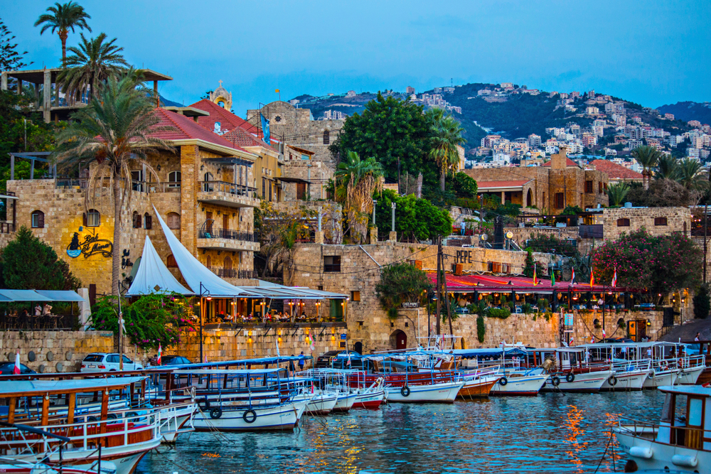 Port in Byblos with boats in the water and colorful buildings for a piece on Is Lebanon Safe