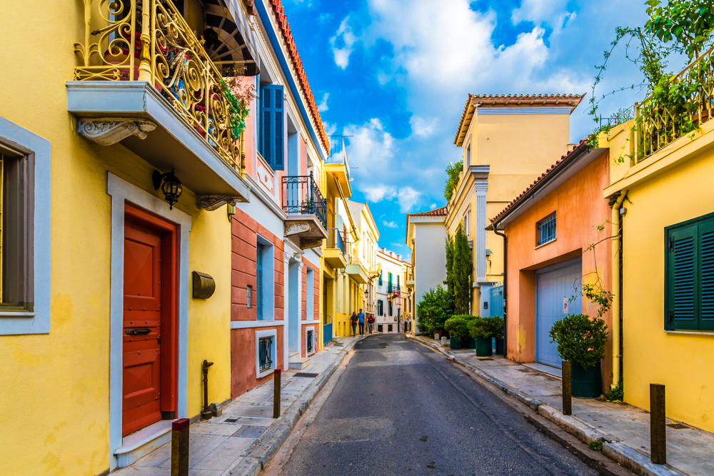Colorful homes in yellow and orange in Plaka pictured during the best time to visit Athens